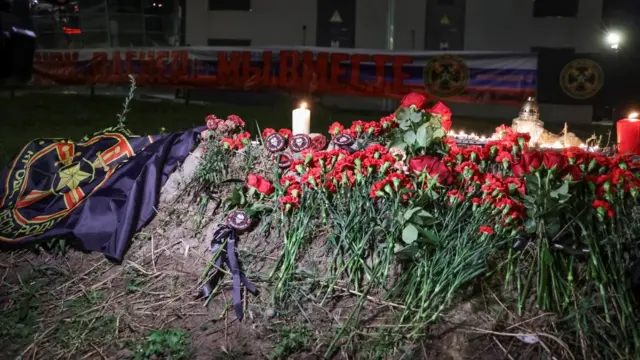 People put flowers and patches at a makeshift memorial near former PMC Wagner Centre in Saint Petersburg, Russia August 24, 2023.