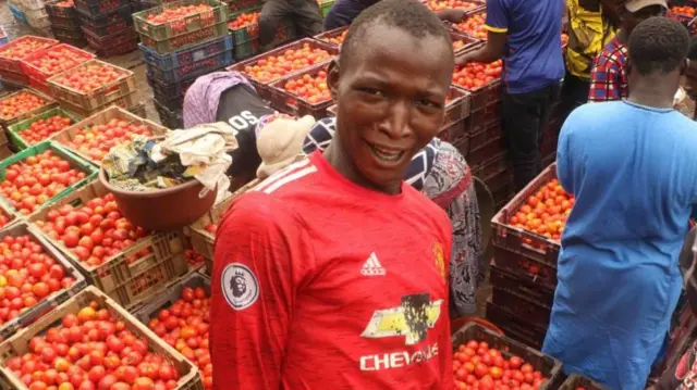 Nigerian people buying and selling tomatoes at the famous tomato market, Lagos, Nigeria