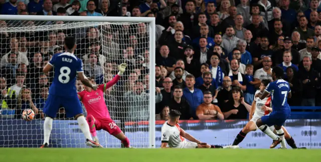 Sterling slots home past sliding defenders for his second goal.