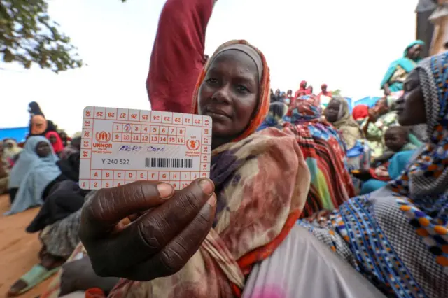 Women who fled the war in Sudan await the distribution of international aid rations at the Ourang refugee camp, near Adre town in eastern Chad on August 15, 2023.