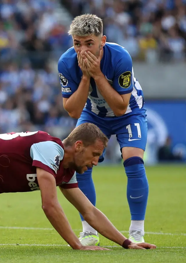 Gilmour holds his hand to his face after missing a chance at goal.