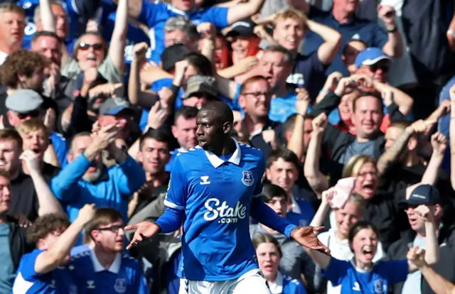 Doucore stands with his arms up in the air as he is flagged offside.