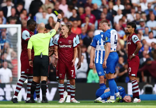 Ward Prowse protests as the ref shows him a yellow card.