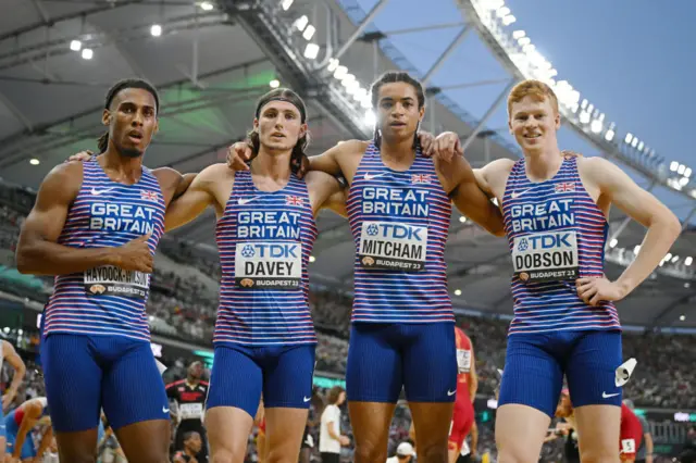 Great Britain's men's 4x400m relay team pose together leaning on each other's shoulders