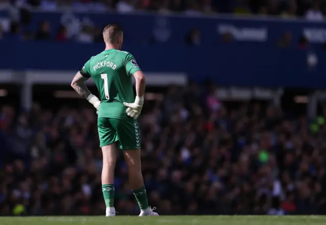 Pickford stands watching the action at the other end of the pitch from his penalty area.