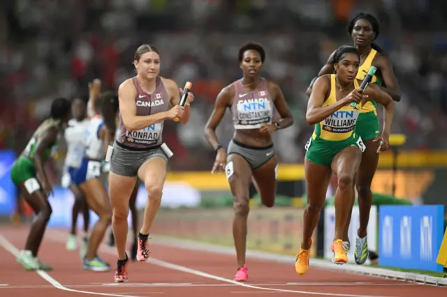 Jamaica and Canada athletes race in the 4x400m relay heats