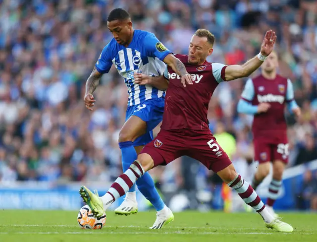 Vladimir Coufal challenges Joao Pedro in West Ham's Premier League game at Brighton