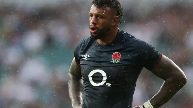 Courtney Lawes stands in the rain