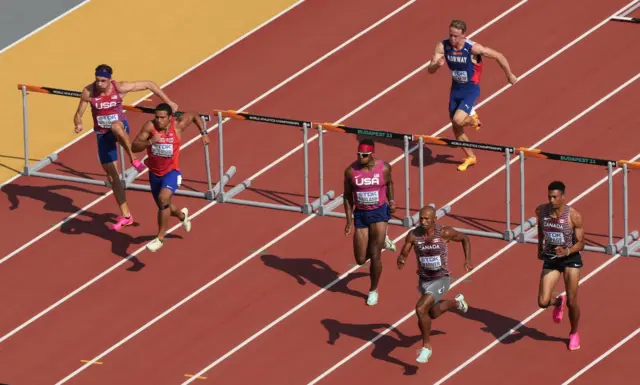 Athletes compete in the 110m hurdles event of the decathlon