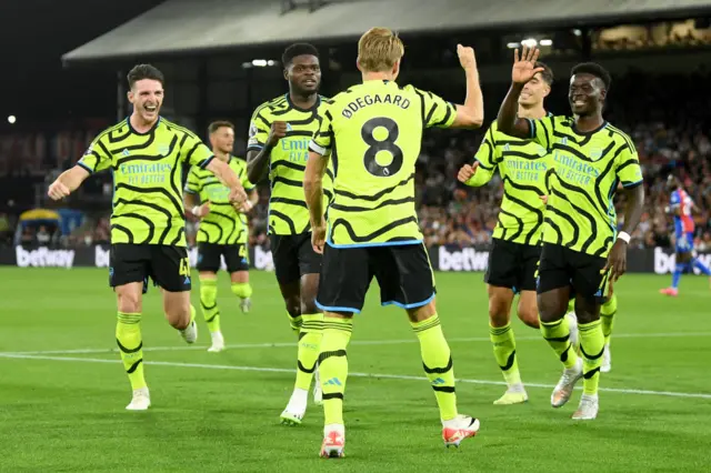 Odegaard celebrates with his teammates after scoring at Palace.