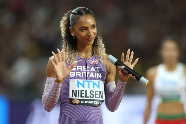 Great Britain's Laviai Nielsen waves her hands as she is introduced on the track