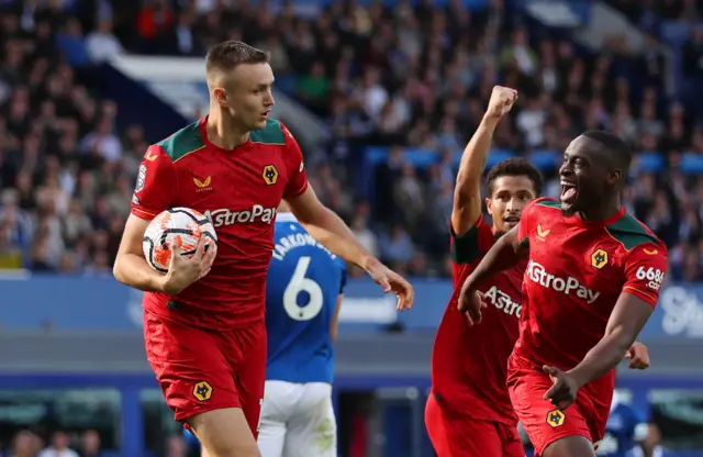 Kalajdzic carries the ball away to celebrate his goal with teammates.