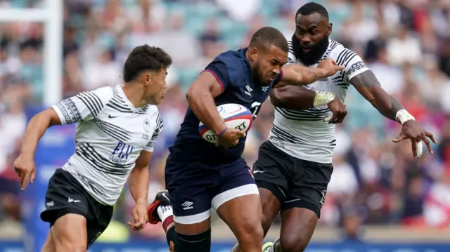 Ollie Lawrence carries the ball for England