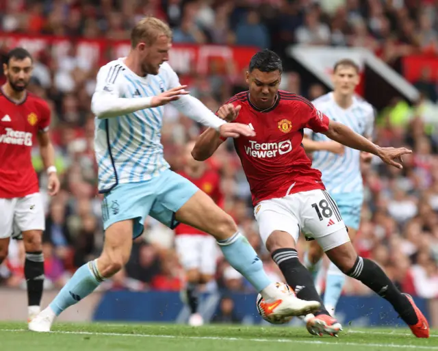 Casemiro of Manchester United in action with Joe Worrall of Nottingham Forest during the Premier League match between Manchester United and Nottingham Forest at Old Trafford on August 26, 2023