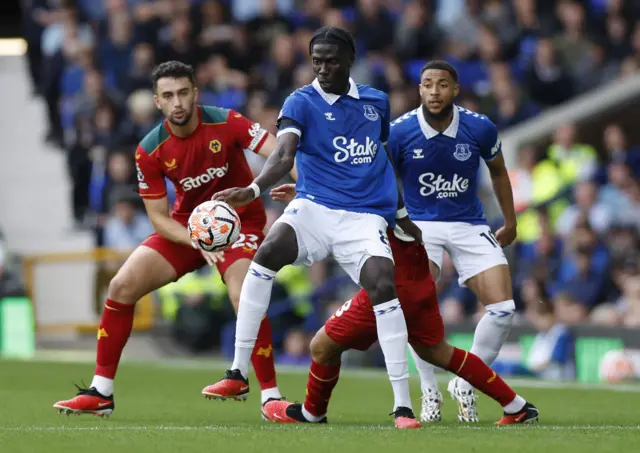 Everton's Amadou Onana in action with Wolverhampton Wanderers' Max Kilman and Joao Gomes