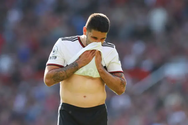 Mitrovic blows his nose into his shirt.