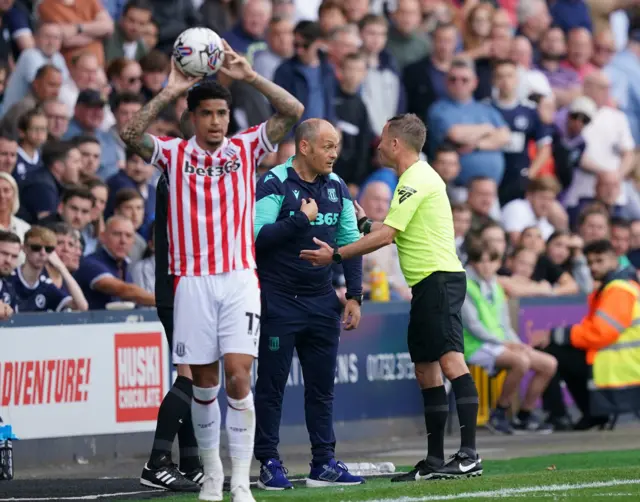 Alex Neil speaks to the referee