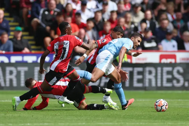 Rodri runs past several challenges from Sheffield UNited players.