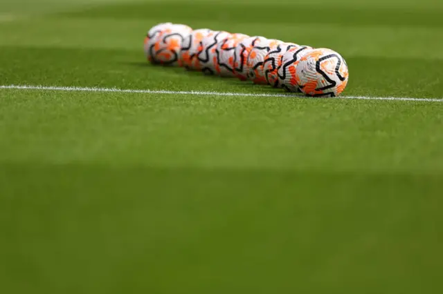 Balls sit waiting on the halfway line for the warm ups.