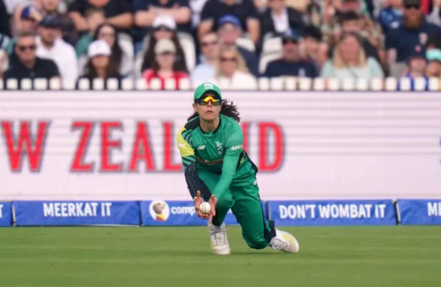 Maia Bouchier takes a diving catch to dismiss Georgia Wareham