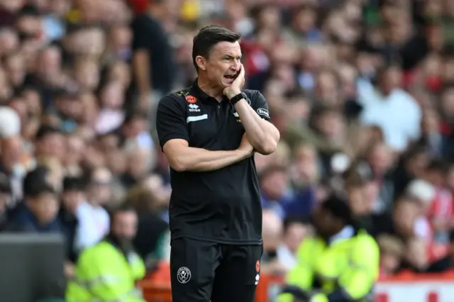 Paul Heckingbottom looks on holding his face.