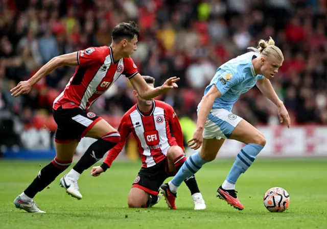 Haaland tries to break away from two Sheffield United defenders.