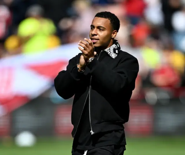 Cameron Archer applauds the fans from the pitch as he is unveiled.