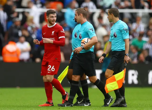 Liverpool's Andy Robertson talking to the referee