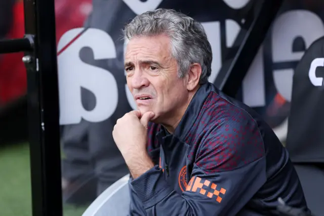 Juanma Lillo looks pensively on the bench scratching his chin.