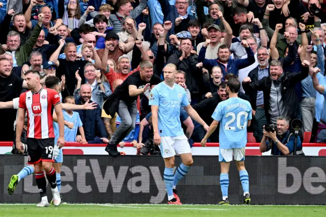 Haaland smiles at his team mates after opening the scoring.