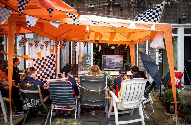 Fans watch the grand prix at Zandvoort in their back garden