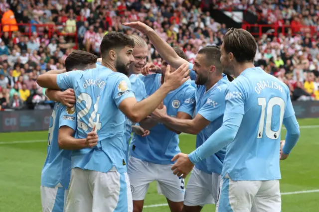 City players celebrate together after Rodri's goal.