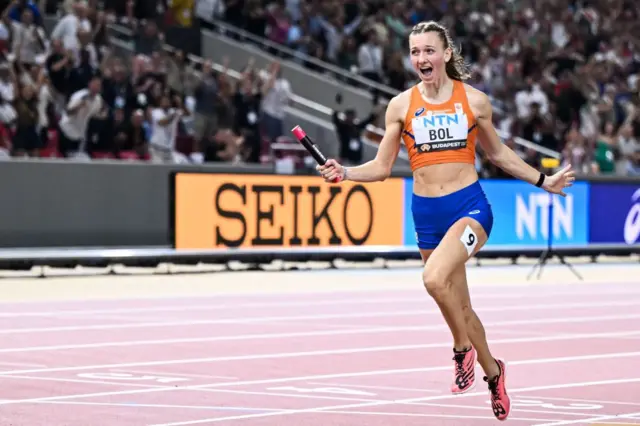 Femke Bol celebrates crossing the line first in the women's 4x400m relay final