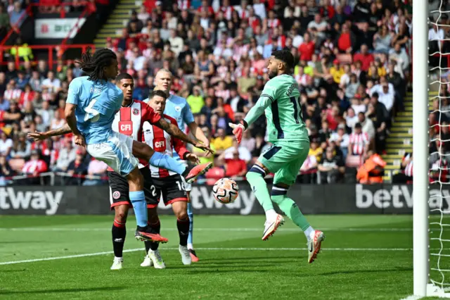 Ake shoots towards goal past Foderingham.