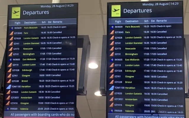 Departure boards at Belfast International Airport