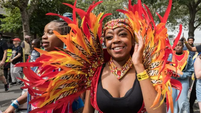 Young performers present their colourful costumes and dance skills during the Children's Parade of the Notting Hill Carnival in London