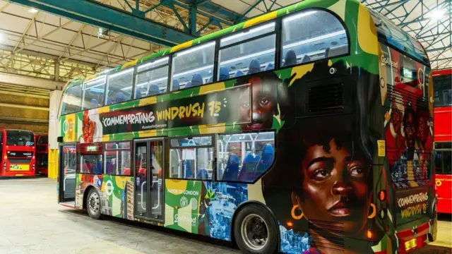 A colourful wrap celebrating the Windrush generation around a double decker London bus