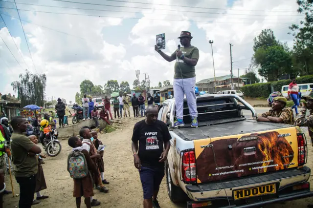 Kenyan elephant campaigner and research scientist, Jim Justus Nyamu (R) speaks to a crowd of people by the roadside about wildlife conservation during his campaign in Nakuru. Kenyan elephant campaigner and research scientist, Jim Justus Nyamu, The Executive Director of the Elephant Neighbours Centre (ENC), has embarked on a walk to sensitize citizens on conservation of elephants in an effort to eradicate poaching and the human-wildlife conflicts.