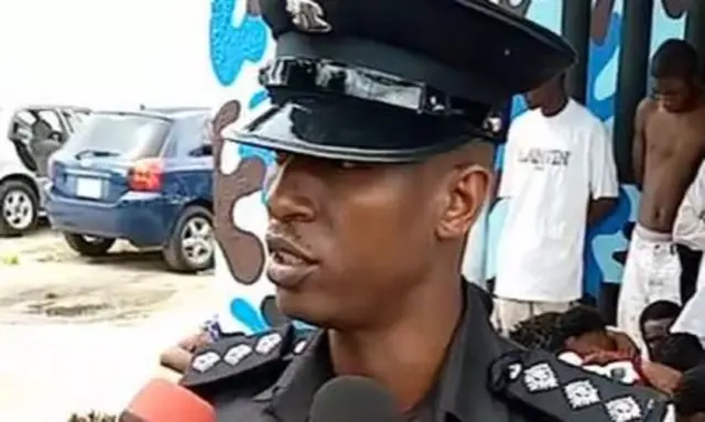 A policeman talking to journalists