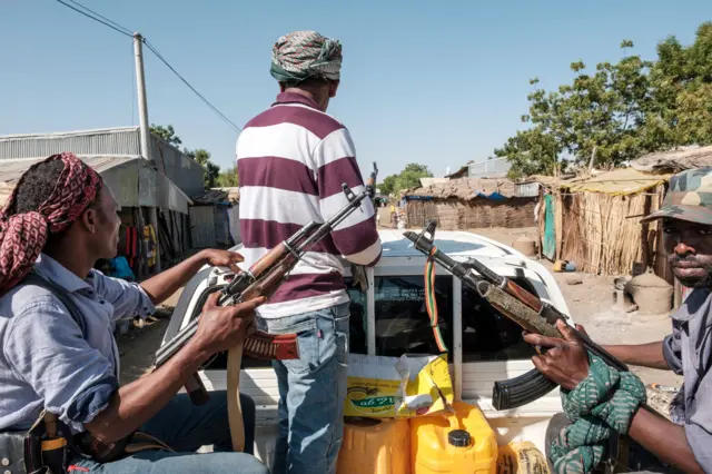 Members of the Amhara militia ride in the back of a pick up truck, in Mai Kadra, Ethiopia, on November 21, 2020. - Amharas and Tigrayans were uneasy neighbours before the current fighting, with tension over land sparking violent clashes.