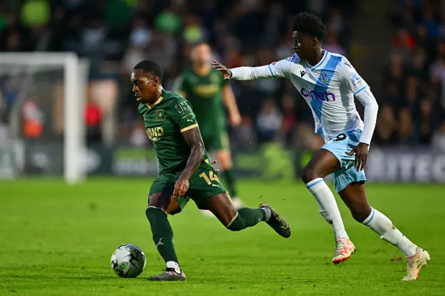 Mickel Miller of Plymouth Argyle is put under pressure by Jesurun Rak-Sakyi of Crystal Palace