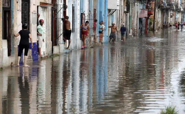 People in Havana near floodwaters