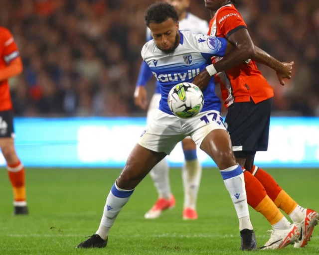 Luton Town's Amari'i Bell attempts to stop Gillingham's Jayden Clarke