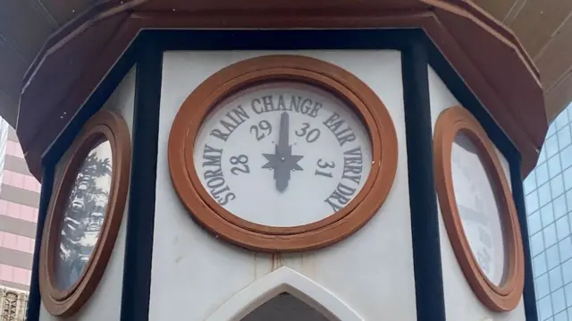 A barometer in downtown Tampa shows "Change"