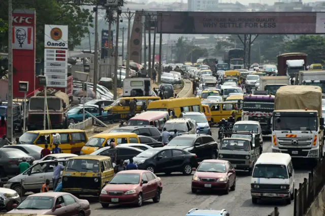 Drivers wait in line to buy fuel at and next to a filling station, causing traffic gridlock on Lagos' Ibadan expressway, in Lagos on January 30, 2023