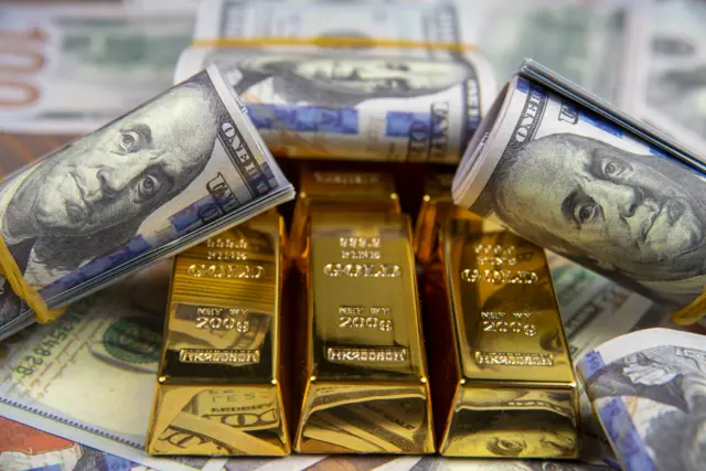 American currency dollar and gold ingot combinations (stock photo)