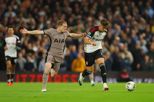 Tom Cairney of Fulham on the ball ahead of Oliver Skipp of Tottenham Hotspur