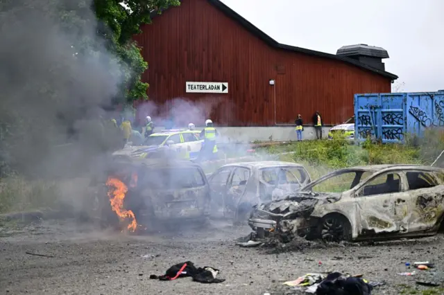 Cars are on fire on the grounds of the Eritrean cultural festival "Eritrea Scandinavia" at Järvafältet in northern Stockholm on August 3, 2023