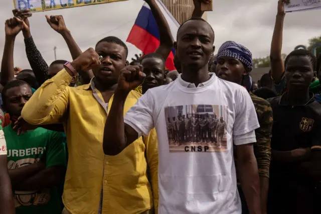 A man wears a shirt in support of the Niger National Council for the Safeguard of the Homeland (CNSP) on independence day in Niamey on August 3, 2023