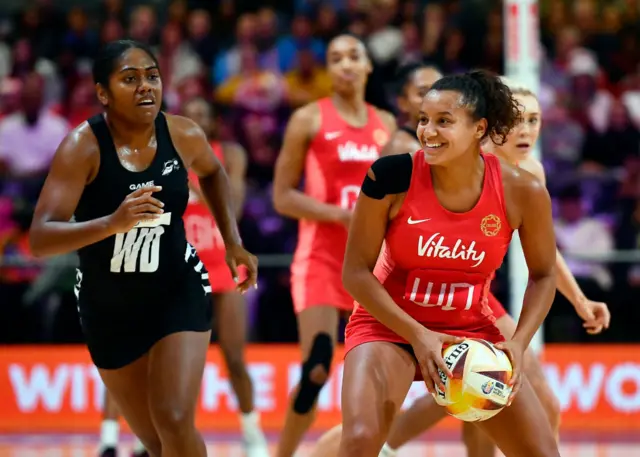 Imogen Allison smiles as she looks for a pass with ball in hand.